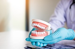 dentist holding removable dentures