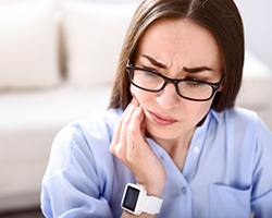 Woman holding jaw in pain