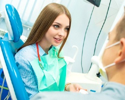 A young woman talking to her dentist
