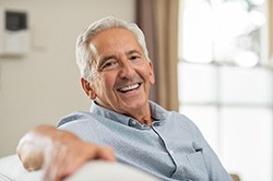 man smiling while sitting on couch