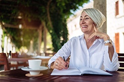 woman smiling while journaling 