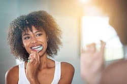 Woman brushing teeth in Weyauwega