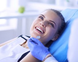 woman smiling while looking at dentist 