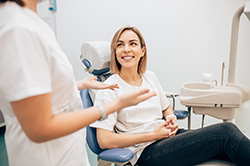 patient smiling while talking to dentist 