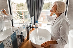 Woman brushing teeth in Weyauwega