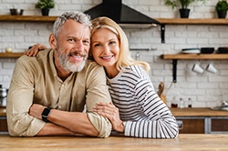 Smiling couple with dental implants in Weyauwega