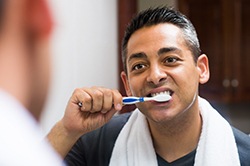 Man brushing his dental implants in Weyauwega