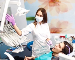 A dentist performing a dental exam.