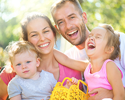 Smiling mother father and two children outdoors