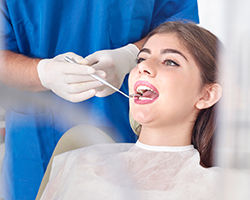 Woman receiving oral cancer screening