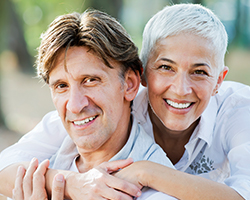 Man and woman smiling outdoors