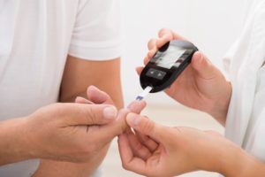 a person having their blood sugar checked