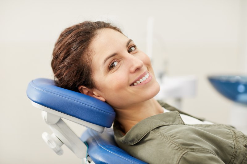 a young woman sitting in the dentist’s chair and waiting to undergo a regular dental checkup and cleaning