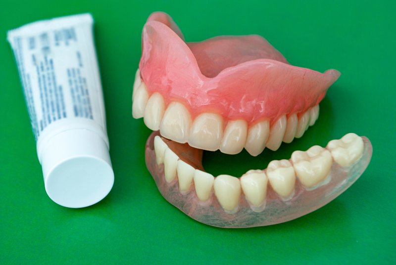 Dentures and adhesive