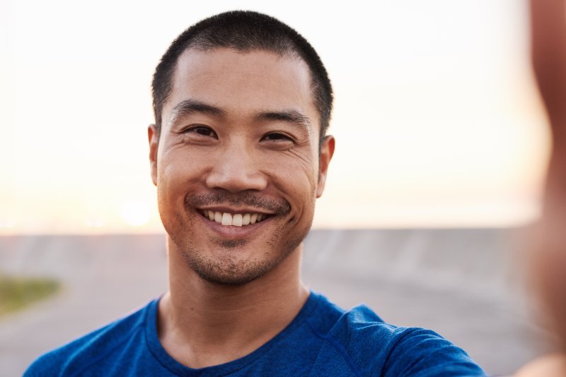 man smiling with dental implants