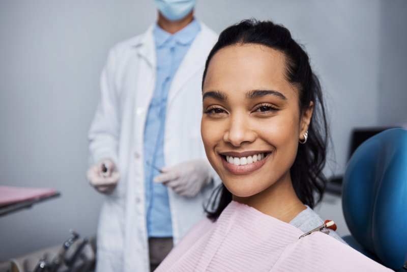 a patient smiling while visiting her dentist
