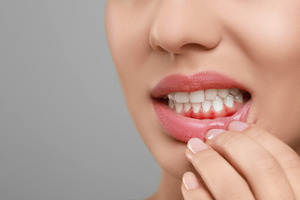 Pulling down lip to show inflamed gums