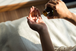 Holding vitamins and supplements in palm of hand