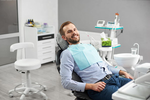 Man sitting in dental chair smiling