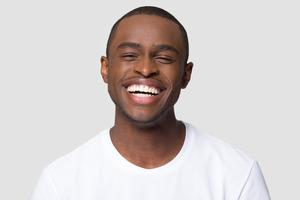 Close-up of man in white shirt smiling