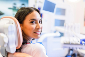 Smiling woman sitting in a dental chair and looking back
